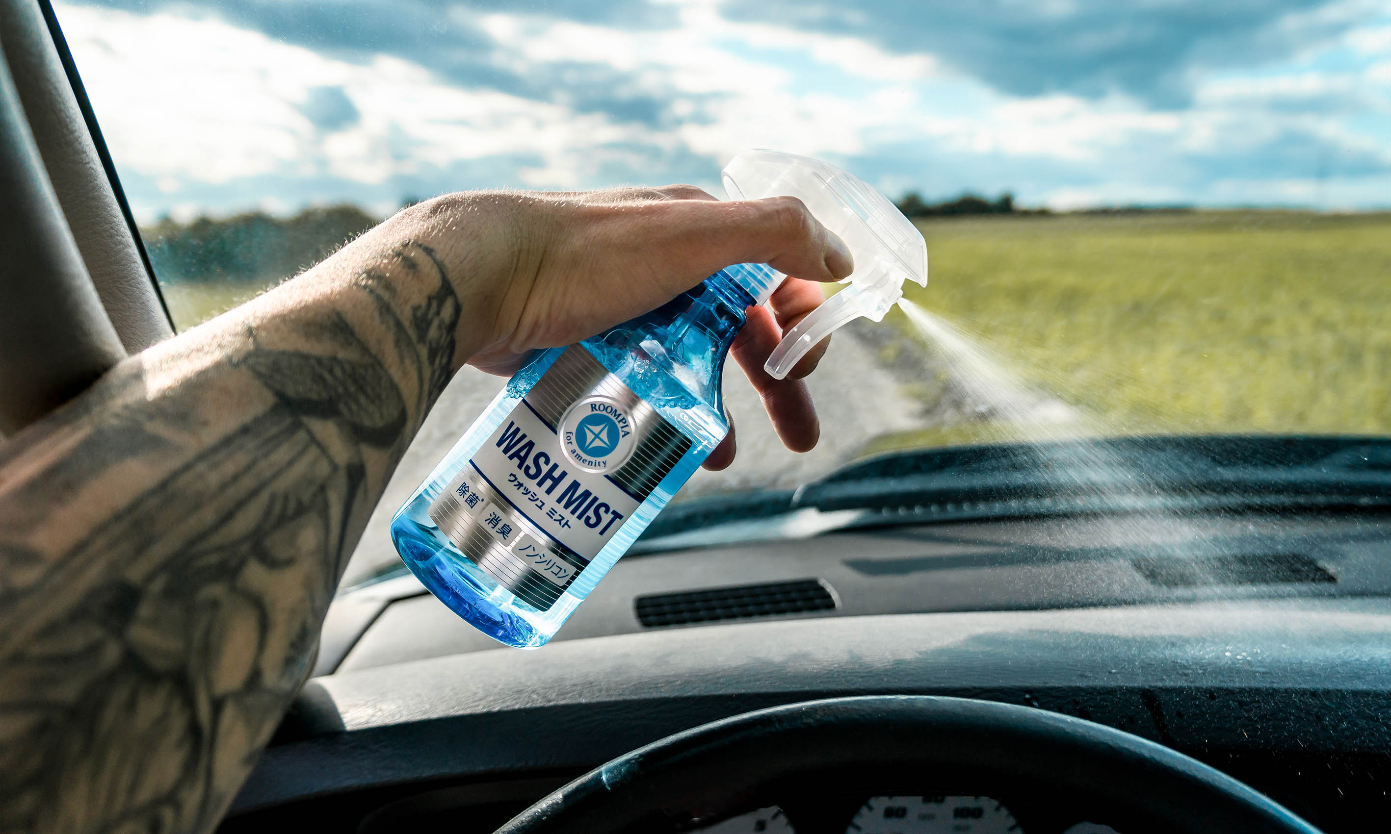 Photo of a Soft99 car care product Wash Mist being used in a car interior.