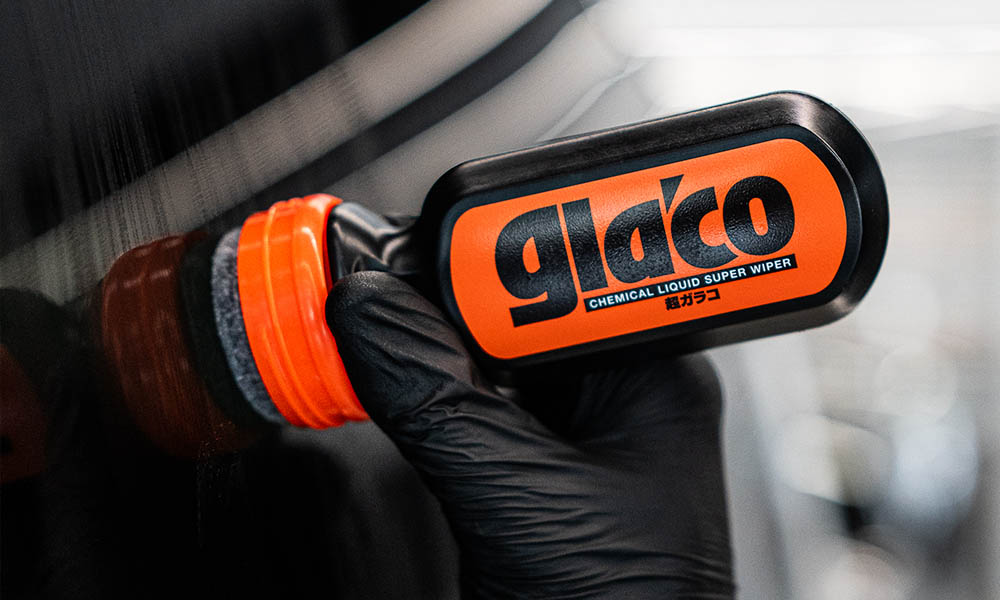 Photo of a Soft99 car care product Ultra Glaco being applied to a car's window.