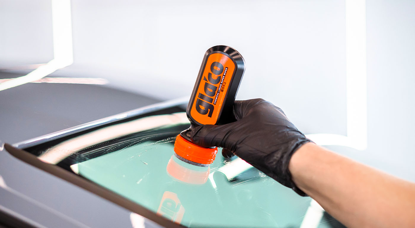 Photo of Soft99's glass coating Ultra Glaco being applied to a car's windscreen.