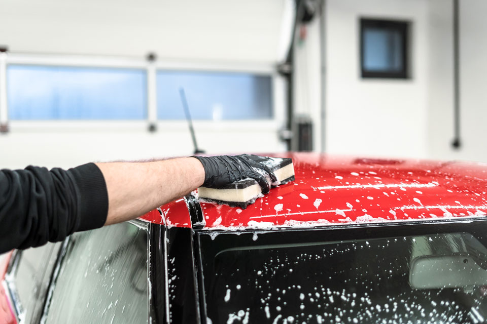 Photo of a Soft99 car care product Neutral Creamy Shampoo being used to wash a car with QJUTSU Ultrasoft Sponge.