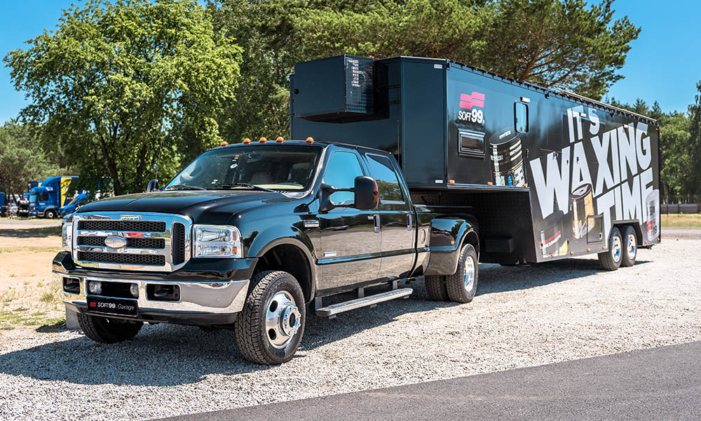 Photo of a shiny, large pick-up truck with a trailer.