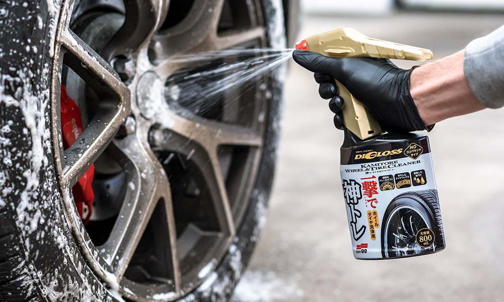 A photo of a Soft99 car care product Digloss Wheel & Tire Cleaner being sprayed onto the car's wheel.